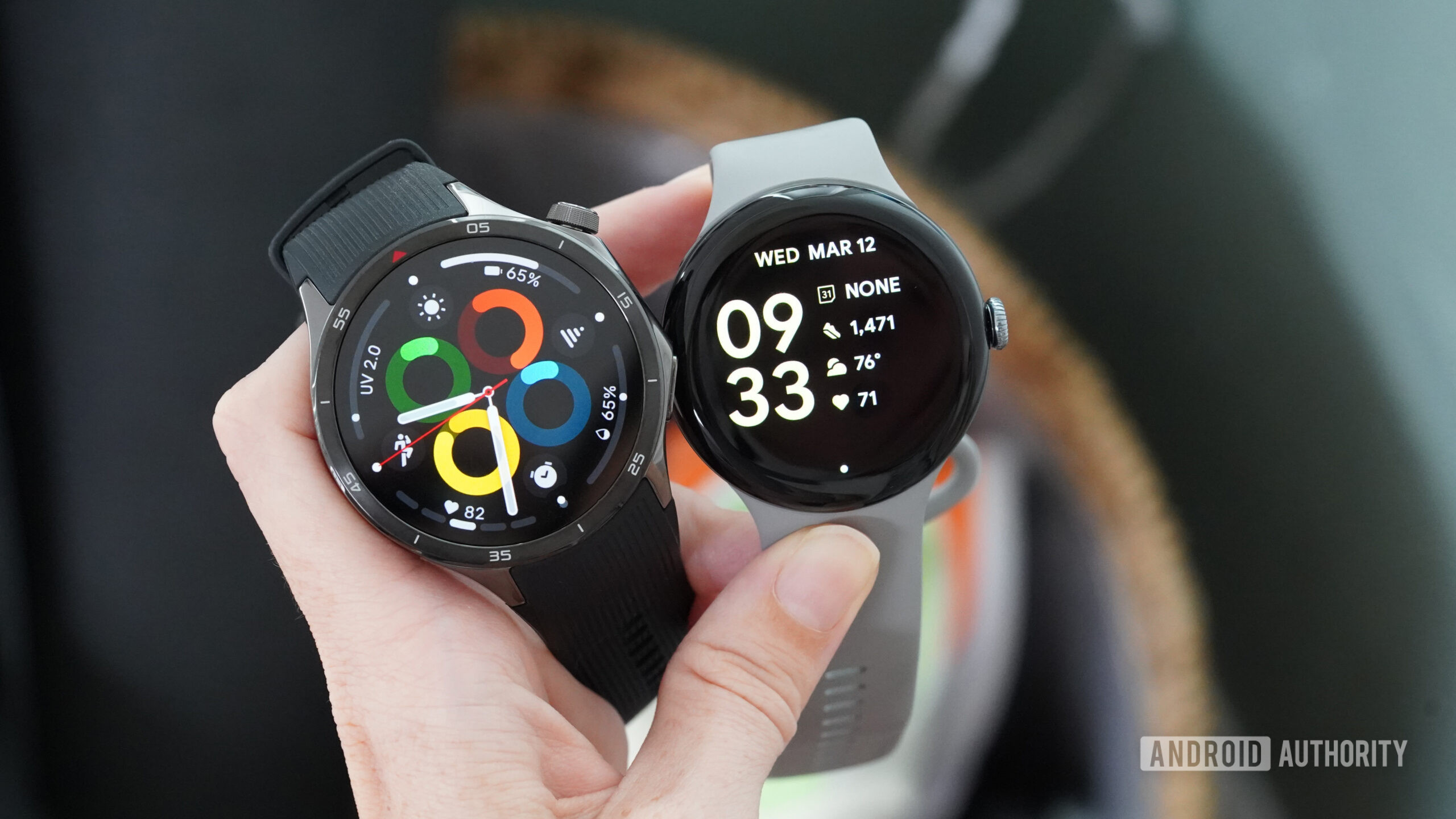 Pixel Watch 3 vs OnePlus Watch 3 A Wear OS user holds both a Pixel Watch 3 and a OnePlus Watch 3.