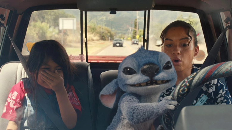 Maia Kealoha as Lilo, Sydney Agudong as Nani white knuckle a truck ride piloted by Stitch in Lilo & Stitch