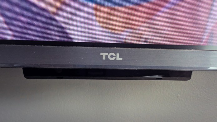 Close-up of a TCL television display with the brand logo visible, showcasing the modern design and edge of the screen.