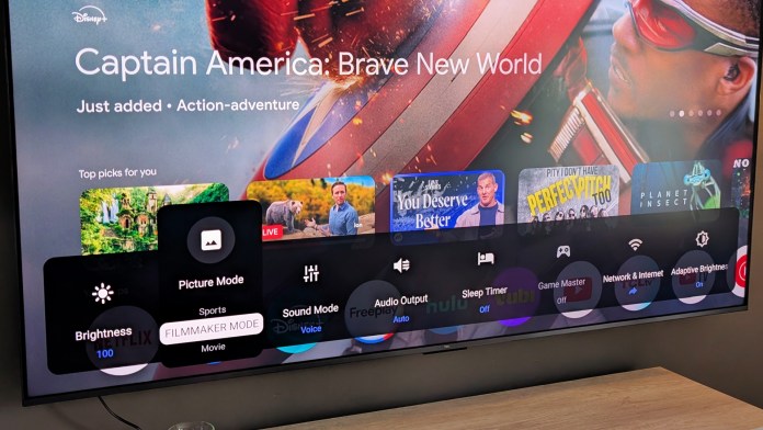 Close-up of the TCL television screen displaying the Disney+ interface with options for picture mode, brightness settings, and a featured title 'Captain America: Brave New World'.