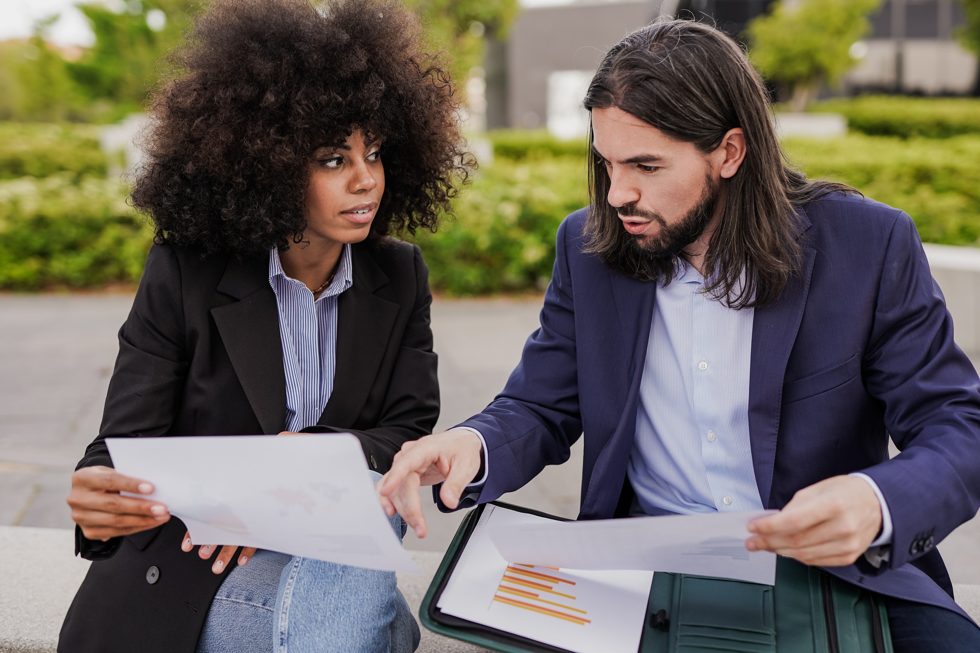 Multiethnic business people analysing statistic outside of office