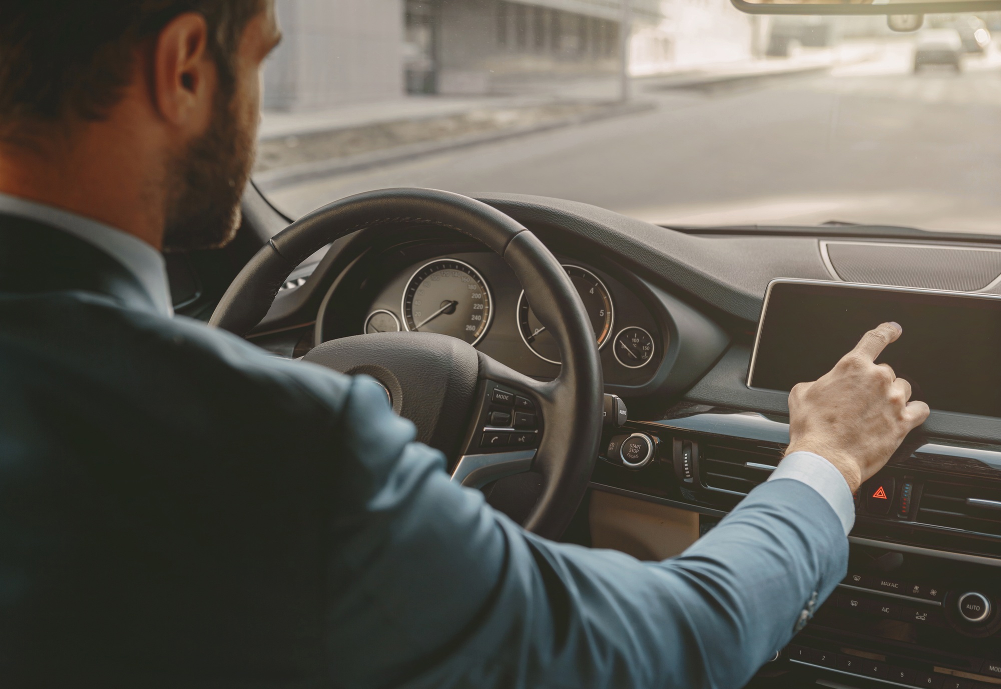 Unrecognized male driving automobile in the city street