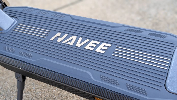 Close-up of the deck of the Navee ST3 Pro electric scooter, featuring the brand name 'NAVEE' in bold lettering.