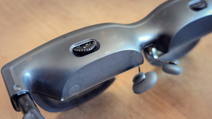 Close-up view of VITURE Luma Pro XR glasses showcasing the design, with buttons and earbuds visible.