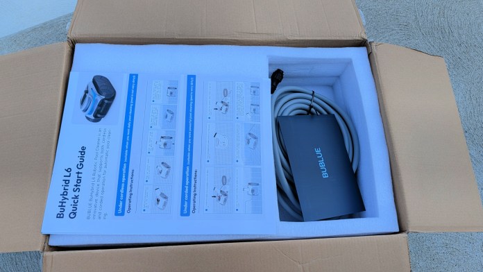 An open cardboard box containing the Bublue BuHybrid L6 Quick Start Guide, a power cord, and packaging materials.