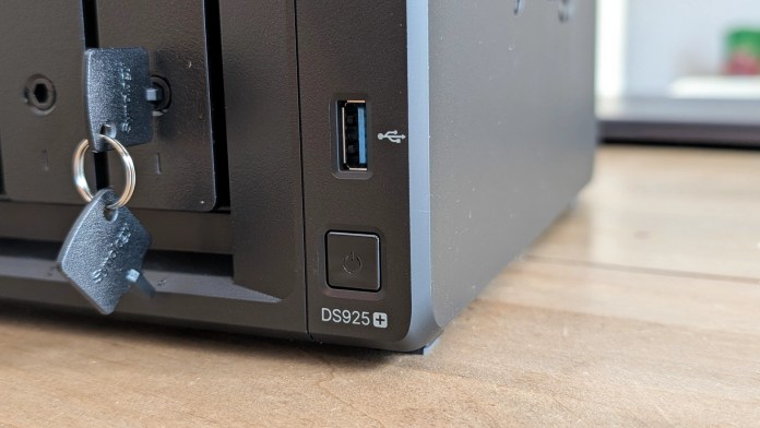 Close-up of the Synology DS925+ NAS unit showing key locks for drive bays, a USB port, and the power button.