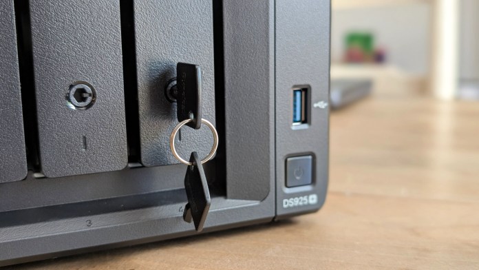 Close-up view of the Synology DS925+ NAS unit, featuring front drive bays with a key lock, USB port, and power button.