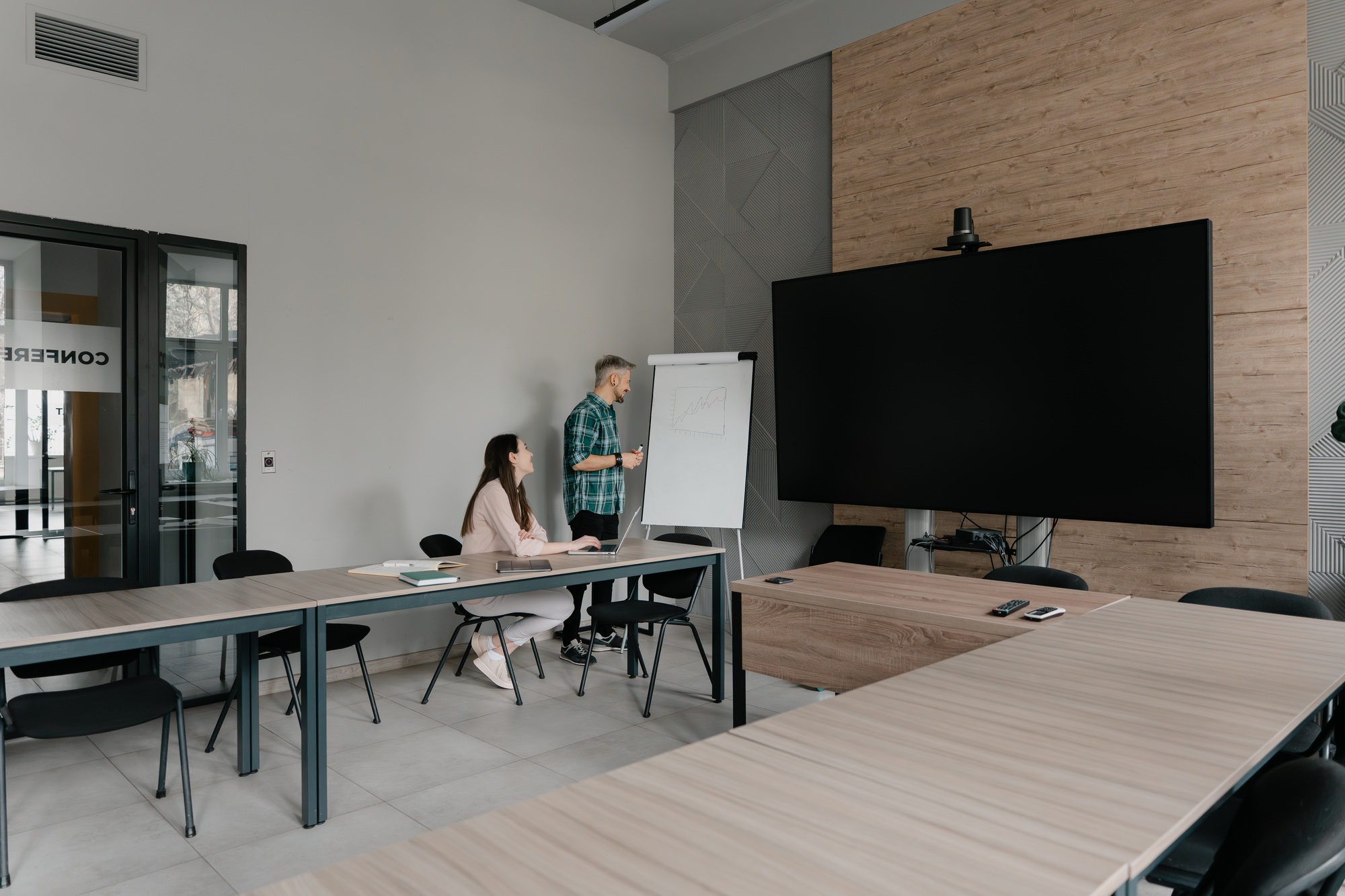 Colleagues collaborating in a modern conference room with presentation materials