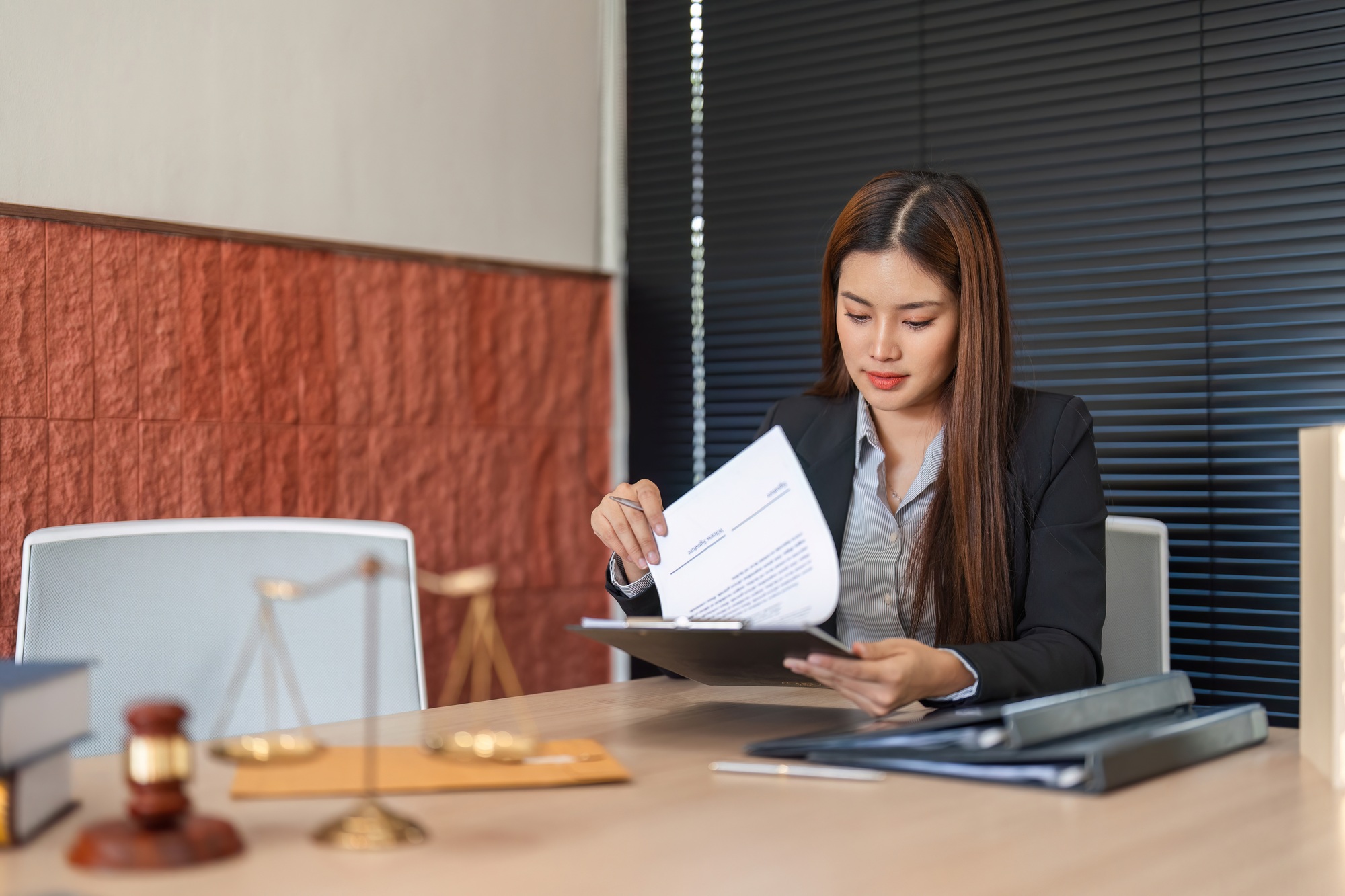 Document Review and Legal Insight. A lawyer analyzing legal documents in a professional setting.