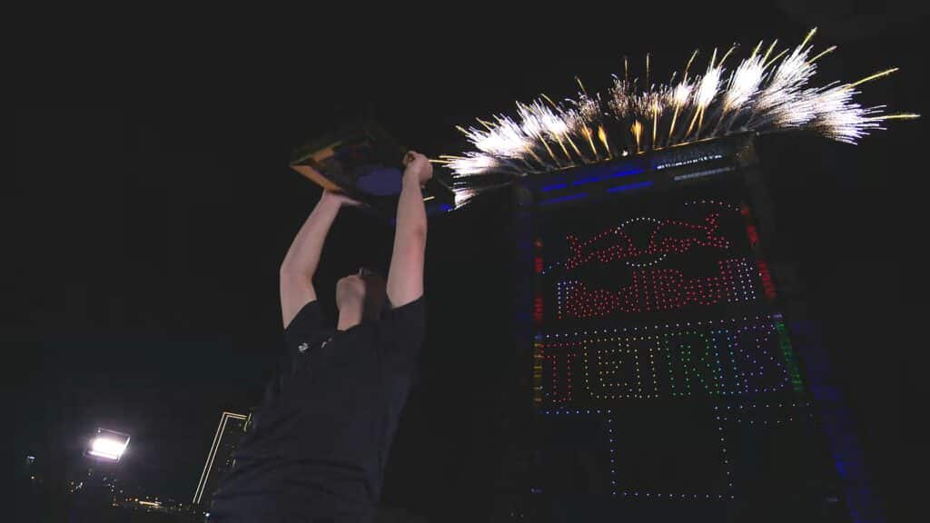 Fireworks erupt as the champion raises the trophy during The Tetris World Finals ceremony