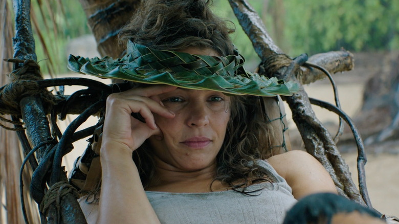Linda Liddle in a green palm frond hat in a hammock in Send Help.