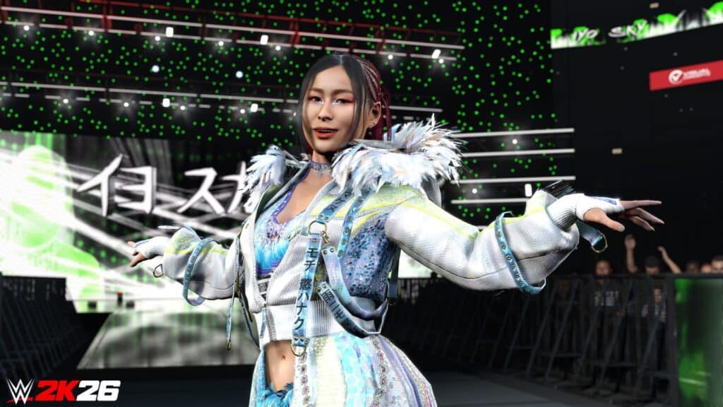 A female WWE 2K26 wrestler poses confidently on the ramp wearing a glittering jacket as the crowd lights glow green in the arena
